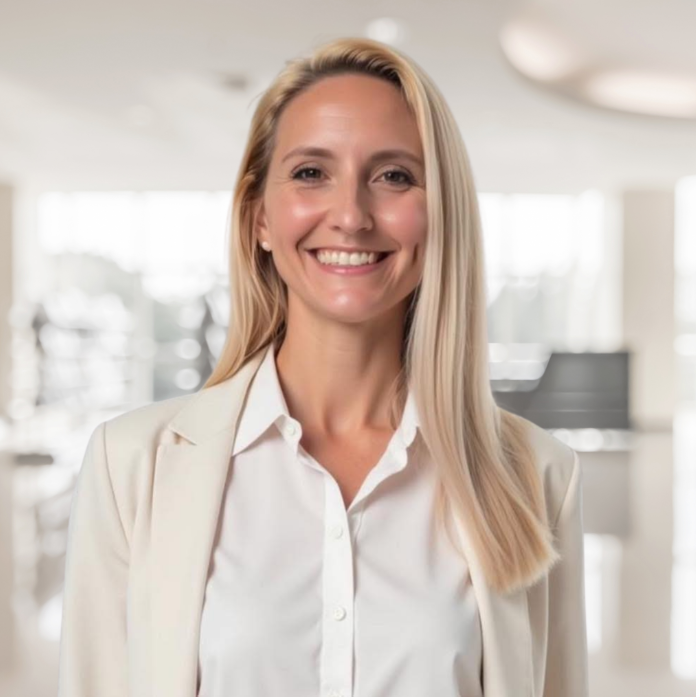 Dr. Megan Nickerson, DNP, smiling in a bright clinical setting