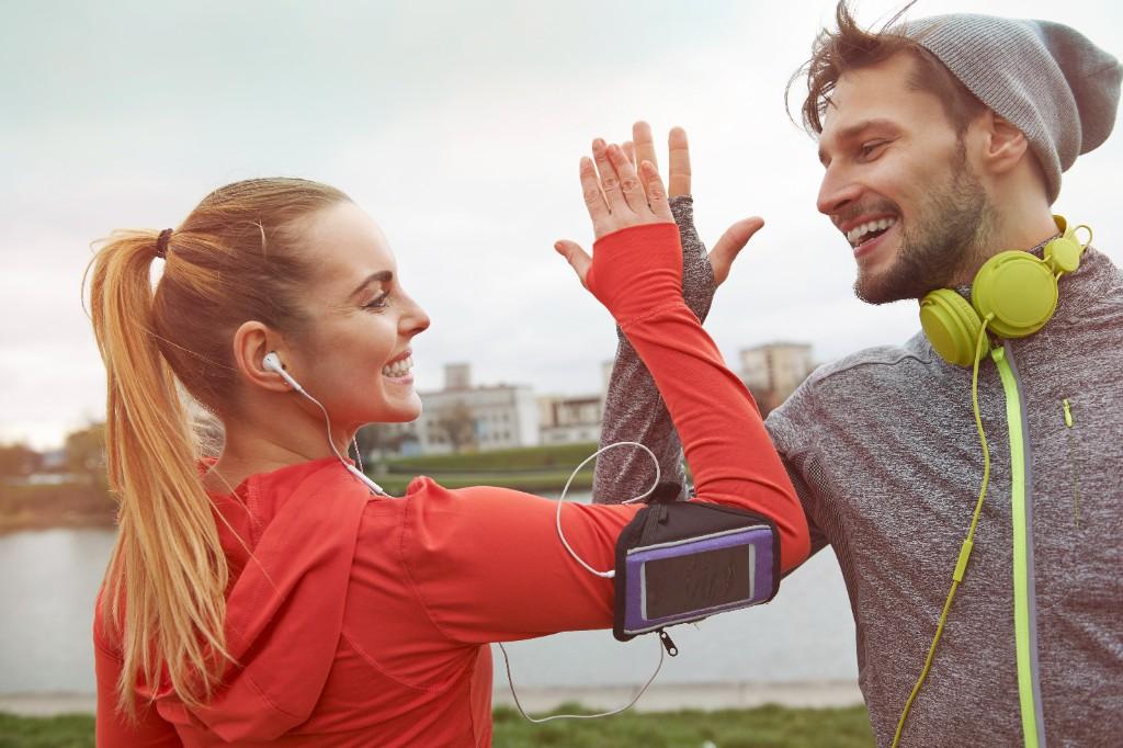 Active couple celebrating a workout outdoors in New York